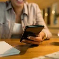 closeup-woman-using-smart-phone-while-learning-evening-home.jpg