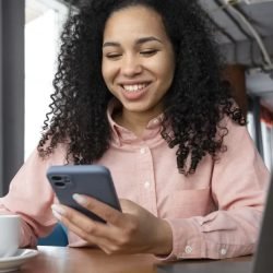 medium-shot-smiley-woman-holding-phone.jpg