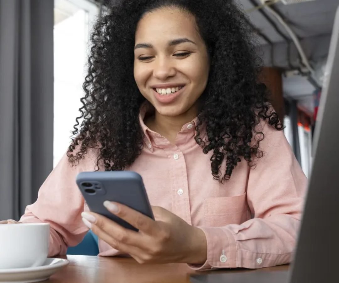 medium-shot-smiley-woman-holding-phone.jpg
